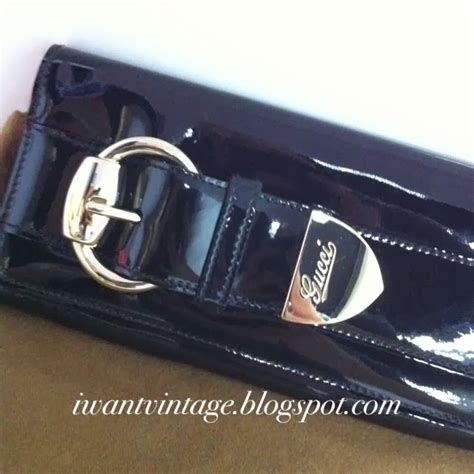 gucci black patent clutch with silver buckle